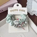Detail of mint green and plaid fabric scrunchie with cute puppy charm and pink bow - Green Bow Ring