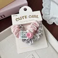 Detail of pink and plaid scrunchies with cute bear label and button on white card - Pink Bear Button Style