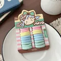 Close-up of pastel kids elastic hair ties in a cute macaron set on a paper display card - Ice Cream Color