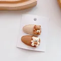 Close-up of two cute brown and white felt bear hair clips on a white display card - Waterdrop Style