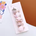 Detailed view of 5-piece pink baby hair clips including bunny and strawberry on a card - Pink Strawberry Style