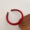 Macro shot of red padded fabric headband showing handmade label and woven texture - Burgundy