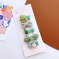 Detailed set of green floral and bow hair clips for girls on a fashion display card - Green Avocado Style