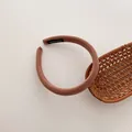 Detailed view of handmade pink ribbed fabric headband with inner woven label detail - Brown