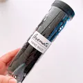 Detail of high-elasticity black hair ties in a clear cylindrical tube for kids - Black Smooth