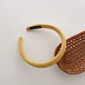 Detailed close-up of yellow knitted fabric headband with handmade textile label - Light Yellow