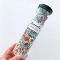 Macro view of multi-color high elastic spiral hair ties in a clear cylindrical tube - Spring Color Threaded Style