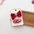 Detail of red bow hair clip and polka dot ribbon set on a white handmade display card - Solid Color Bow Set