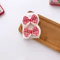 Close-up of red and white houndstooth bow hair clips with soft plush trim on card - Houndstooth Style / Red And White Houndstooth Bow
