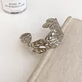Close-up detail showing the silver hollowed leaf pattern and crinkle texture of this cuff bracelet - Hollow Laurel Leaf Style (57#) / Silver