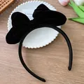 Detail of the oversized black velvet bow headband on a wooden background for girls - Black