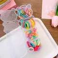 Detail of four-tier bear-shaped storage case filled with colorful elastic hair ties and star clips - 3-Star Claws
