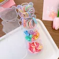 Detail of bear-shaped organizer box filled with colorful elastic hair ties and mini clips - 4-Strawberry Claws