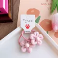 Detail of pink fabric flower hair ties with pearl centers on branded display card - Pink Flower