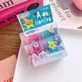 Close-up of baby size multi-color elastic hair ties in a cute star design plastic box - Ice Cream Colors