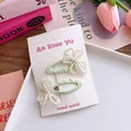 Close-up of handmade green fabric hair clips with elegant white pearl bow details - Light Green