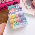 Macro shot of macaron colored high elastic hair ties in a transparent storage box - Macaron Colors