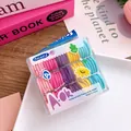 Detailed view of boxed baby hair ties in five bright colors on a clean white tray - Rainbow Colors