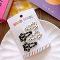 Detailed view of four star-shaped polka dot BB hair clips on a handmade card display - Star Polka Dot