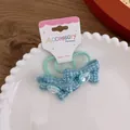 Detailed shot of blue tweed bow hair ties with heart gems in a white ceramic tray - Blue Bow / Blue