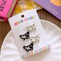 Set of four butterfly hair clips with polka dots on a handmade card in a styled layout - Butterfly Dot Pattern