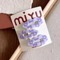 Detailed view of three purple cloud-shaped hair clips with cute cartoon prints on card - Cloud Scalloped Edge (6-Purple Cartoon) / Purple Cartoon Set