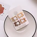 Set of four matte earth-toned wave hair clips on a handmade presentation card - Animal Style