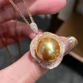 Close-up of luxury golden pearl pendant necklace with sparkling diamond setting. - Champagne Large Pearl Pendant Necklace / Gold