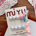 Detail of sequined mermaid tail hair clips with pearls and stars on a display card - Colorful Mermaid Tail Style (250358)