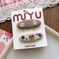 Detail of handmade embroidered BB hair clips with daisy and bear motifs on cards - 5-Khaki Bear BB Clip Style