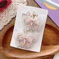 Detailed view of handmade lace butterfly hair clips with embroidery and white pearls - Orange Butterfly