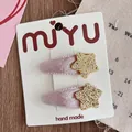 Detailed view of handmade pink velvet hair clips with glittering gold stars on card - Velvet Wrapped BB Clip / Gold Star