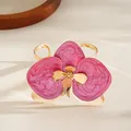 Elegante bracciale a polsino con fiore di orchidea dorato e smalto rosa vibrante - Bracciale rigido aperto / Rosa