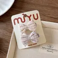 Detail of handmade floral and plaid bow hair clips on a premium white display card - Light Purple