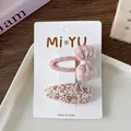 Detailed view of pink plaid bow and floral fabric BB clips on display card - 3-Plaid Bow Style