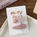 Detail of pink fabric bow hair clips and polka dot clip on a white display card - 5-Plaid Bow Snap Clip Style
