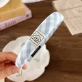 Detail of blue plaid fabric headband featuring a cute dog patch and positive quote - Headband