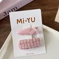 Detail of sweet pink fabric bow hairpins and tweed clip on a display card for girls - 6-Elegant Tweed Style