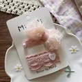 Detail of pink chiffon bow hair clips with pearls and lace on a decorative display - Flat Bow Tie Snap Clip / Pink