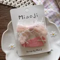 Detailed set of sweet pink tulle bow and fabric hair clips on a white ceramic flower plate - Swallowtail Bow Snap Clip / Pink