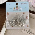 Detailed view of grey elastic hair ties with pearls on a cute illustrated blue card - Silver Knot