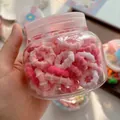 Close-up of pink and white elastic hair bands in a clear storage jar for girls - Rose Pink