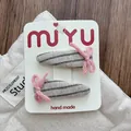 Detail of pink knitted bow hair clips with grey striped fabric on white display card - Stripe Pink Gray