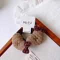 Detail view of brown croissant fabric scrunchies and plaid bows on a card - Heart Hair Tie