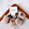 Close-up of brown elastic hair ties with beige bows and floral center on a display card - Large Bow Style