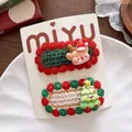 Detail of knitted Christmas hair clips featuring cute reindeer and festive tree charms - Reindeer Style