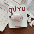 Detailed view of handmade pink fabric bunny hair clip with floral ear and pearl detail - Rabbit