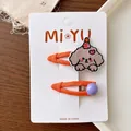 Close-up of kids embroidered puppy hair clips and purple bead pins on card display - Brown Dogs