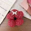 Detail of red floral scrunchie with white polka dots and a small bow accent - Red Polka Dot