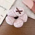 Close-up of pink and white checkered fabric flower hair scrunchie with small brown ribbon bow - Pink Plaid